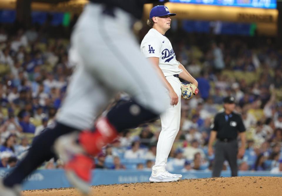 Dodgers pitcher Landon Knack looks on as Cleveland's Andres Gimenez rounds the bases after hitting a home run.