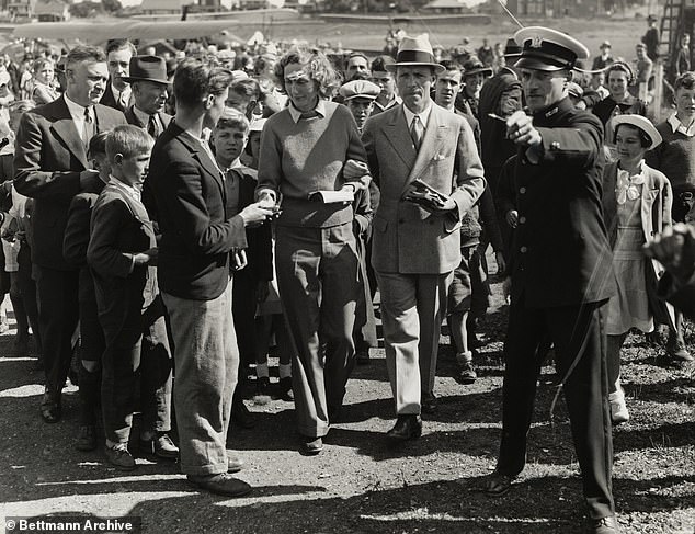 A crowd of autograph seekers crowds Beryl Markham after her solo flight over the Atlantic