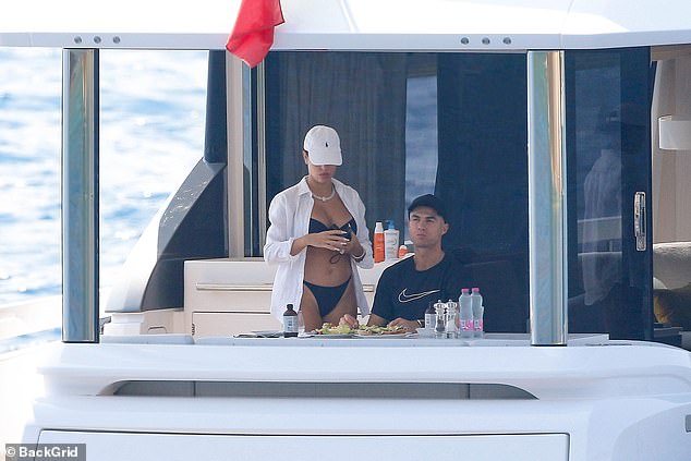 The couple chatted to each other as they sunbathed, before heading into the sea for a dip.