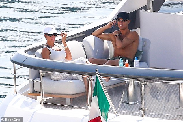 After lunch, the couple relaxed in the sun on sun loungers while Ronaldo answered a few phone calls.