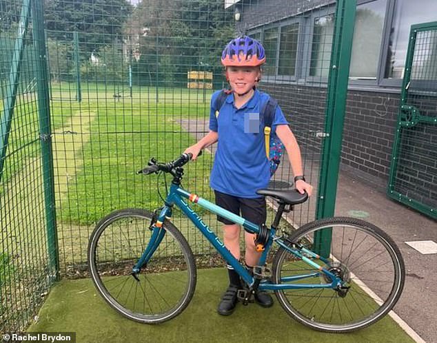 Nine-year-old Freddie pictured with his bike outside the school.