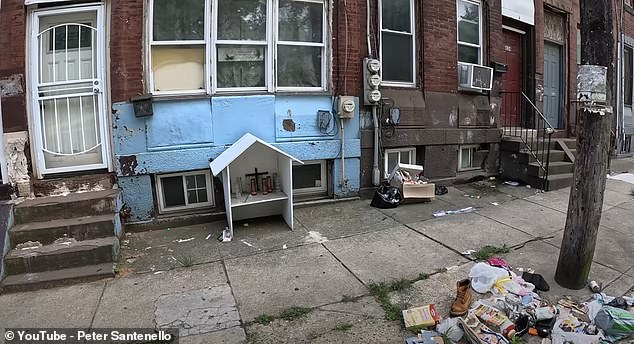 As Peter and Buddy walk through the trash-strewn streets, they see a small shrine marking the spot where someone died.