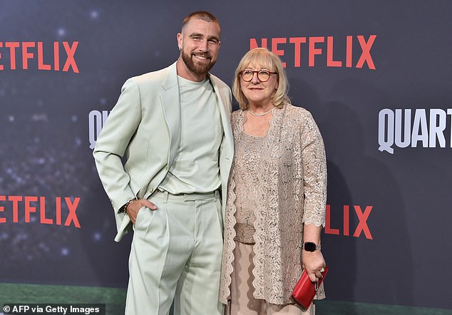 Travis poses with his mother on the red carpet for Netflix's Quarterback last summer