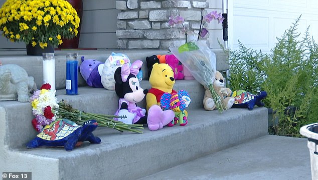 Friends, family and neighbors piled flowers and stuffed toys on the steps in memory of the deceased.