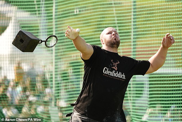 A competitor throws a 28-pound weight during the Braemar Gathering Highland Games