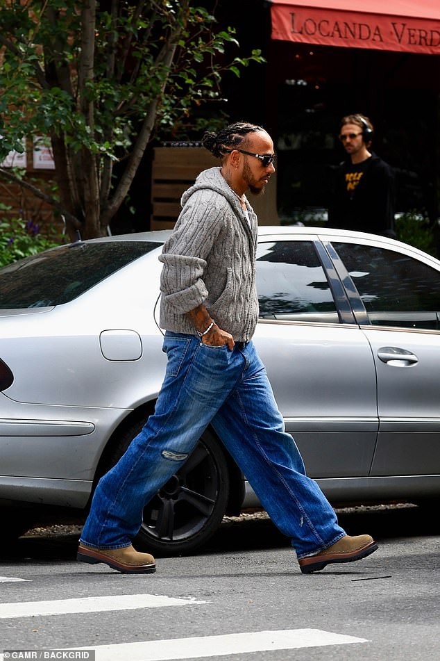 The athlete added a simple white t-shirt underneath his hoodie along with a pair of chunky tan boots.