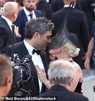 She was seen leaving to give her fiancé a loving kiss, despite wearing a veil over much of her face.