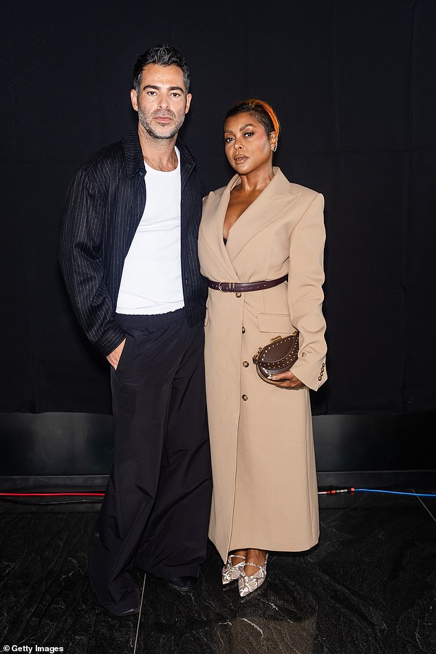 She carried a brown clutch as she posed with designer Jonathan Simkhai.