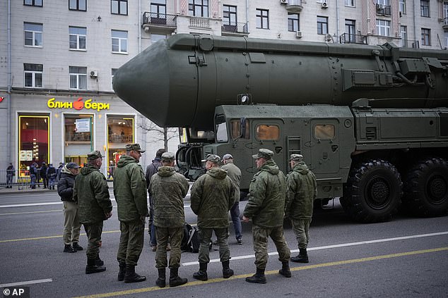 Soldiers stand next to a Russian RS-24 Yars ballistic missile parked along Tverskaya Street before a rehearsal for the Victory Day military parade in Moscow.