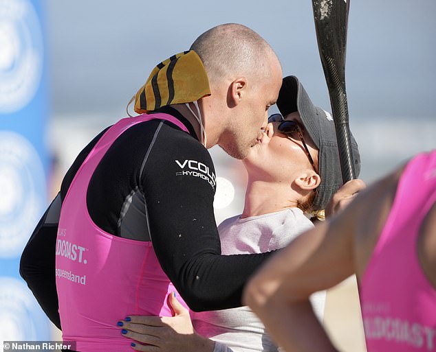 Lily, 25, was on hand to give her man a sweet kiss after he emerged from the water wearing a pink and black wetsuit and carrying a paddle.