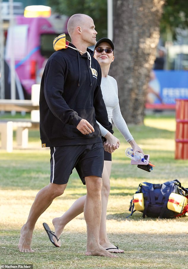 Jett donned a black hoodie and shorts as he walked barefoot.