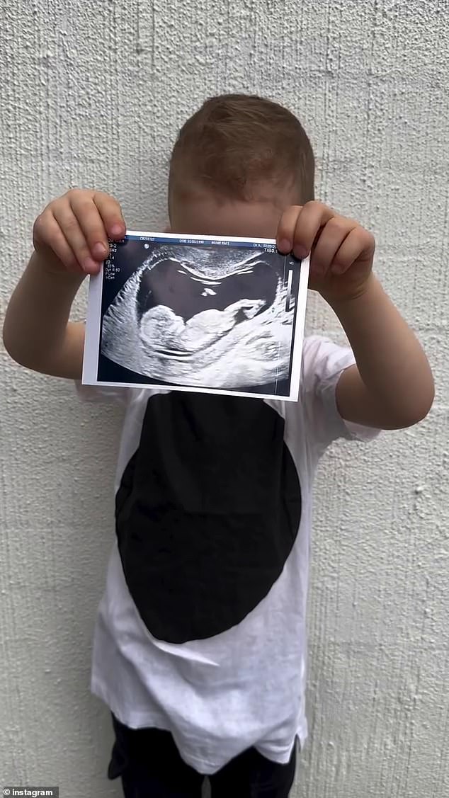 The Collingwood Premiership defender shared the news on Instagram on Sunday alongside images of his adorable son Zander. In the video, the three-year-old is seen holding an ultrasound scan against a whitewashed wall.