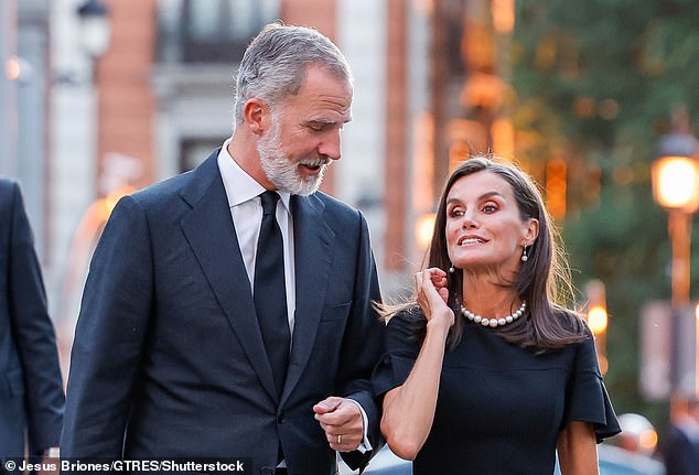 Queen Letizia wore her shoulder-length brown hair loose and slicked back behind her ears to reveal a pair of pearl earrings.