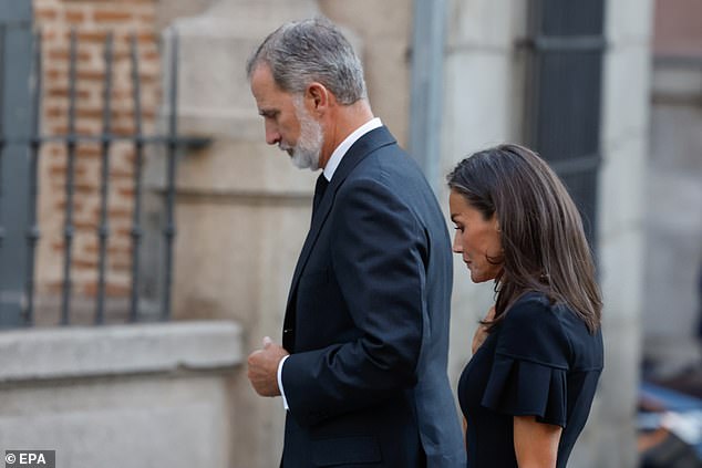 King Felipe and Queen Letizia bowed their heads as they paid their respects.