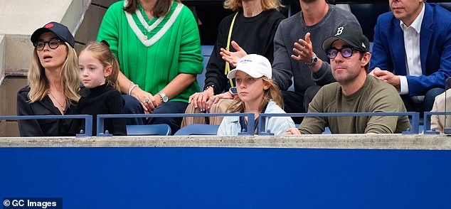 The doting parents sat on either side of their children. Seven-year-old Violet took turns sitting on her parents' laps, while 10-year-old Hazel seemed to enjoy watching the action on the court.