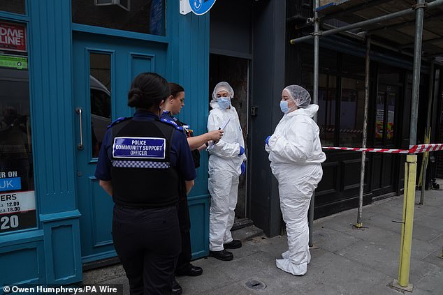 Police forensic investigators enter the disused building in Bishop Auckland on July 31