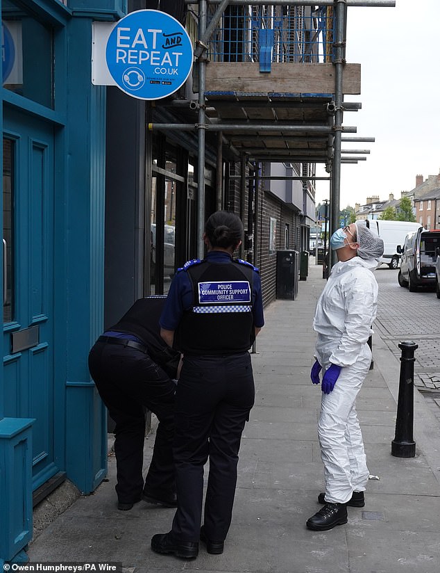 Police forensic investigators enter the disused building in Bishop Auckland on July 31