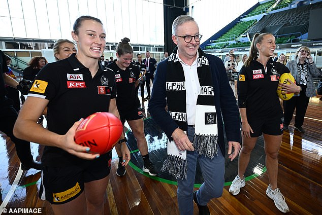 I'm not a fan: here's the Prime Minister in his Collingwood scarf in September last year...