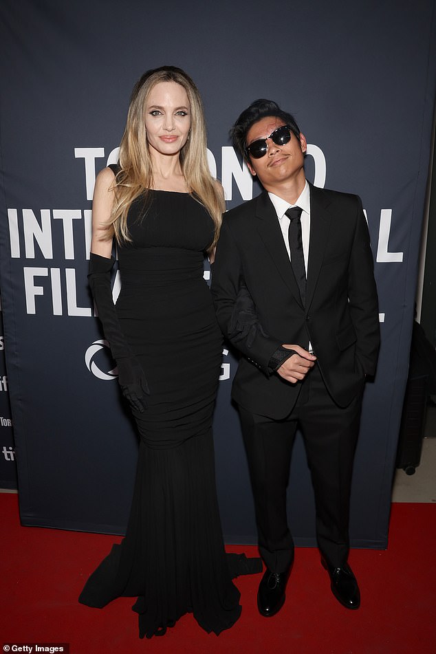 The 49-year-old star and her son Pax, 20, posed together as they arrived on the red carpet at the premiere of her film Without Blood at the Toronto International Film Festival on Sunday night.