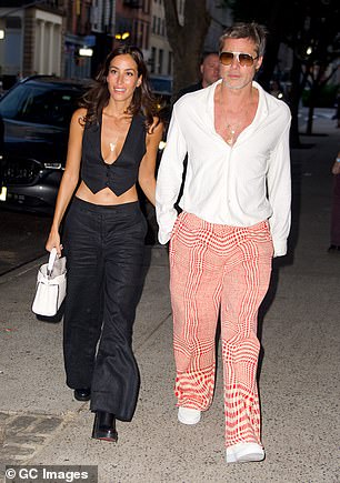 The Fight Club star looked handsome in a white button-down shirt, which he left unbuttoned at the top to reveal his long necklace, and his girlfriend was also seen modelling a plunging top.