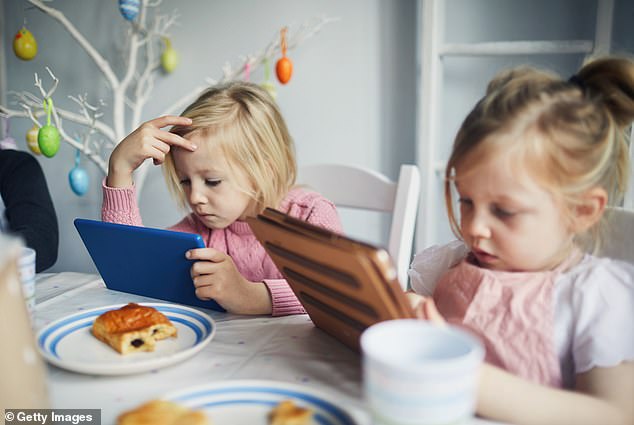 Nearly two-fifths of parents surveyed said they struggled to interact with their children at mealtimes, and three in ten said they rarely talked as a family while eating (file image)