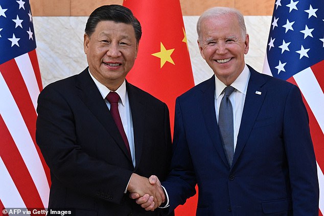 US President Joe Biden (R) and Chinese President Xi Jinping (L) shake hands as they meet on the sidelines of the G20 Summit