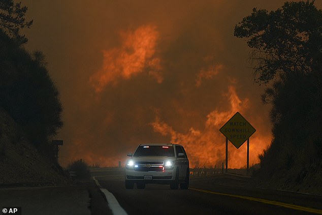 The Line Fire skips Highway 330 as an emergency vehicle passes by on Saturday, September 7.