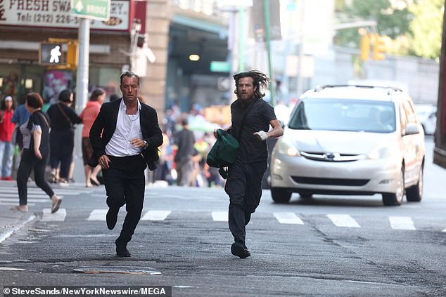 In another photo, the duo are seen running down the street with Jason carrying a large bag as they were chased by a car.