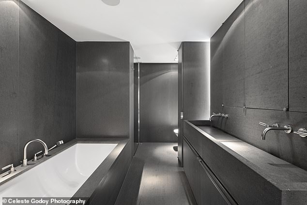 Shown here is one of three elegant stone-clad bathrooms.