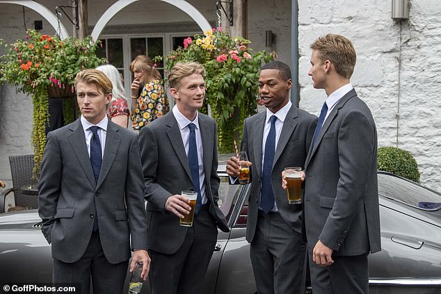 The bride was walked down the aisle by her eldest son, while her three other children walked ahead of her.