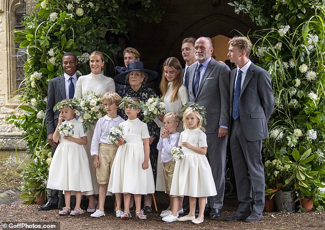 The bride and groom accompanied by their five children, the bride's mother and her flower girls and page boys.