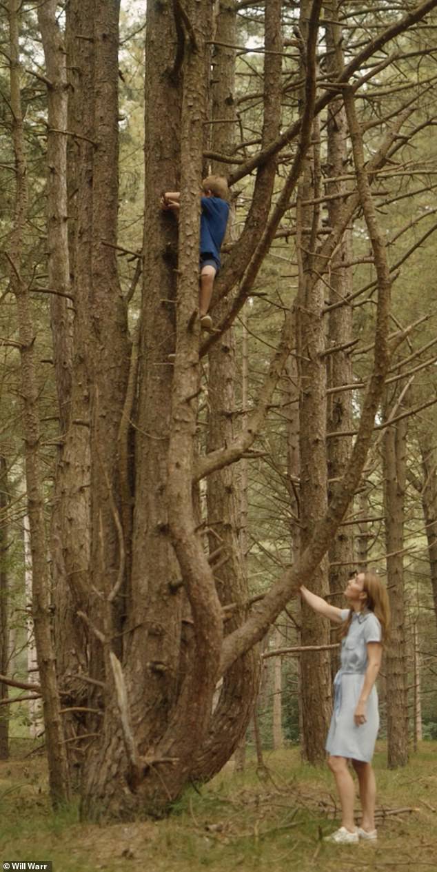 Cheeky Louis is seen climbing a tree as his mother watches.