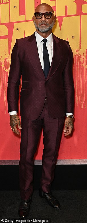 To promote his latest film, in which he plays a veteran assassin, the American star looked noticeably slimmer in a patterned maroon suit.