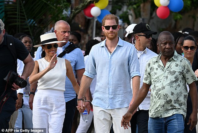 Prince Harry and Meghan, pictured in San Basilio de Palenque in Colombia on August 17