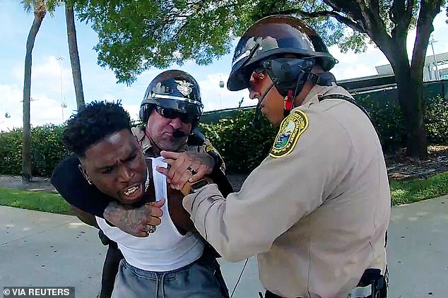 Miami Dolphins star receiver Hill was handcuffed by police in dramatic scenes as he headed to his opening NFL game.