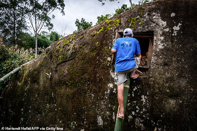 A member of the Toraja ethnic group opens the grave of his relatives during the traditional ritual known as Manene in Pangala, South Sulawesi, on August 27, 2024.