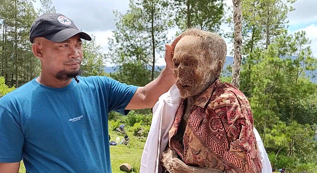 Villagers were seen posing with their dead ancestors, who had dry, papery skin after spending years underground.