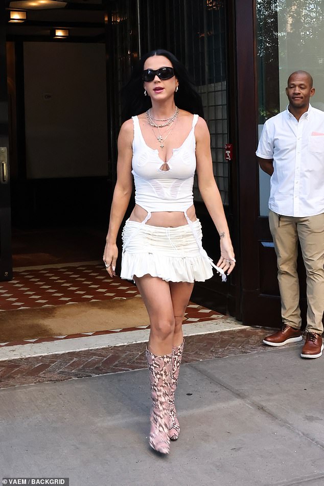 Katy paired the fitted top and ruched mini with snakeskin boots and layers of necklaces.