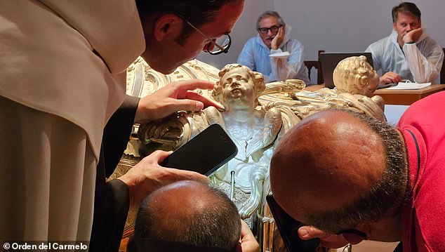 The team has not released photographs of St Teresa's remains, saying only that they have remained undisturbed since her body was last exhumed in 1914. Pictured: The marble-clad silver coffin of St Teresa of Avila.