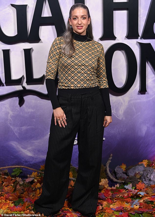 Radio DJ Harriet Rose looked lovely in a tan wrap-print jumper and loose-fitting black pinstripe trousers.