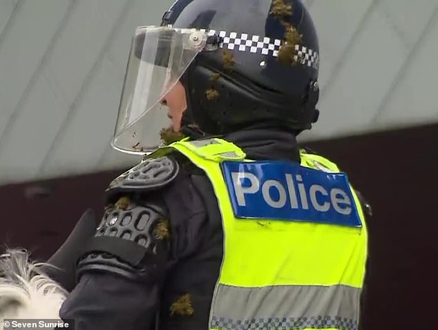 Officers were seen with feces stuck to their helmets and uniforms as they attempted to control the crowd.