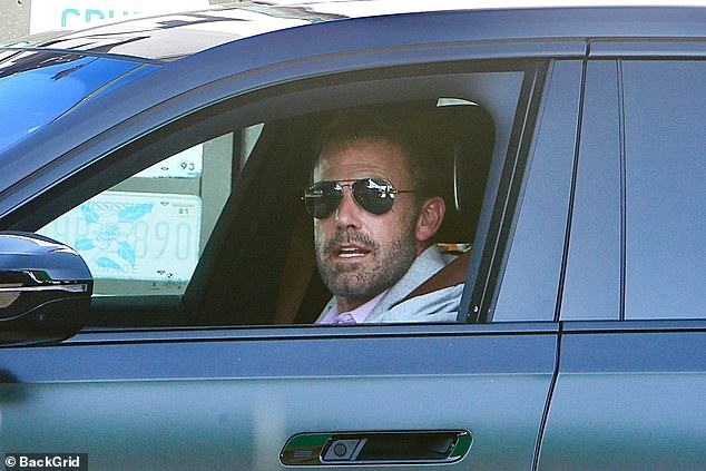 The Batman star sported a pair of black aviator sunglasses and showed off some facial hair during the trip.