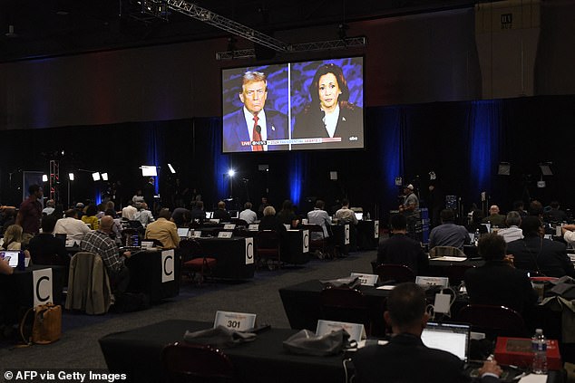 Journalists and members of the media look on from the press room as US Vice President and Democratic presidential candidate Kamala Harris and former US President and Republican presidential candidate Donald Trump take part in a presidential debate at the National Constitution Center in Philadelphia.