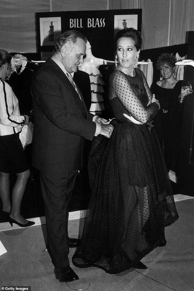 Fashion designers Bill Blass and Donna Karan try on a Blass evening gown at the 7th Ave on Sale AIDS charity sale