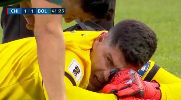 The goalkeeper was taken away on a stretcher, visibly emotional and with his head in his hands, while the fight continued.