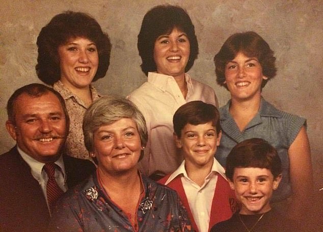 Pictured: Colin and Marian Gray posing for their family portrait with their siblings and parents.