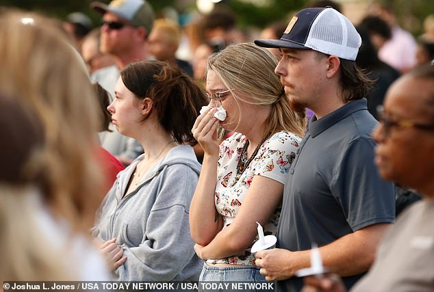 Mourners are seen gathered at a vigil on the night of the shooting at Apalachee High School in Winder, Georgia.