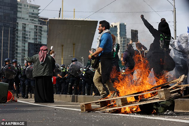 Protests erupted into chaos in Melbourne on Wednesday when demonstrators set fire to rubbish.