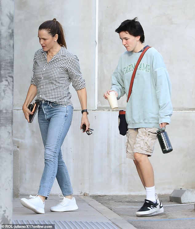 The 52-year-old actress looked casually chic as she modeled a black and white gingham print blouse paired with skinny jeans and white sneakers.