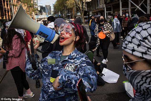 The woman's appearance in an Australian Air Force Cadet uniform sparked outrage, with online commentators calling for her to be immediately kicked out of the junior military program.